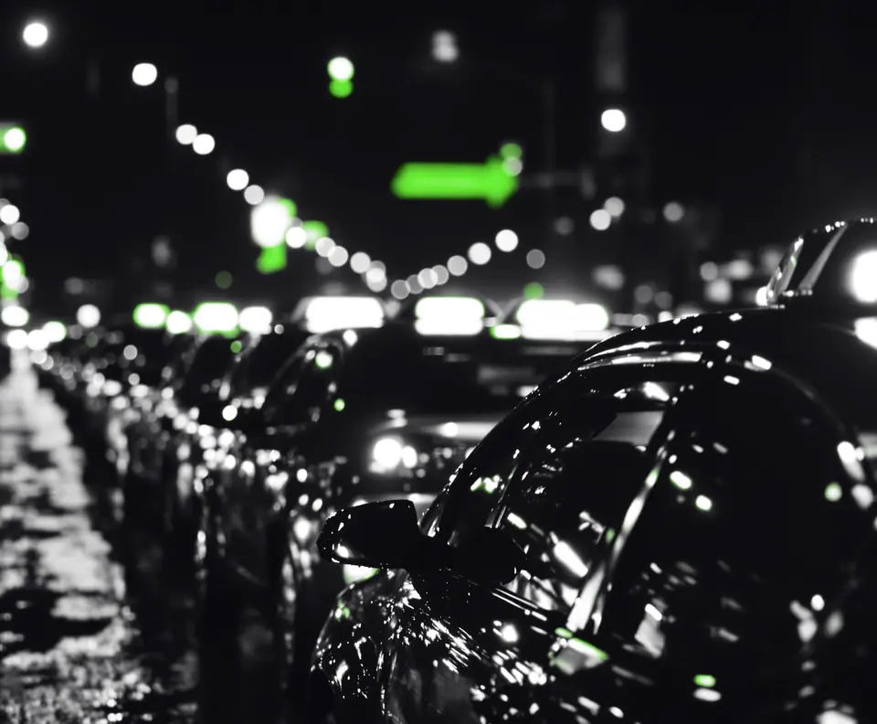 Row of taxis parked on a wet avenue at night: Starkapital custom SaaS lending core case study